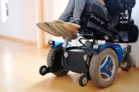 How does a tilt in space wheelchair differ from a reclining back wheelchair?