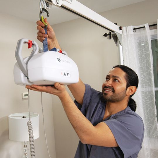 If your portable track is low enough, you can detach the lift by using your hands (shown above). If your ceiling track is higher, you will need to purchase a reacher arm if you wish to detach the lift (not shown). 