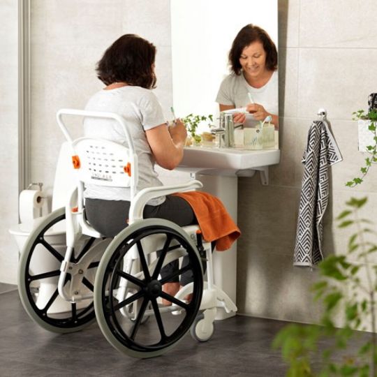 Clean self-propelled commode shower chair in use