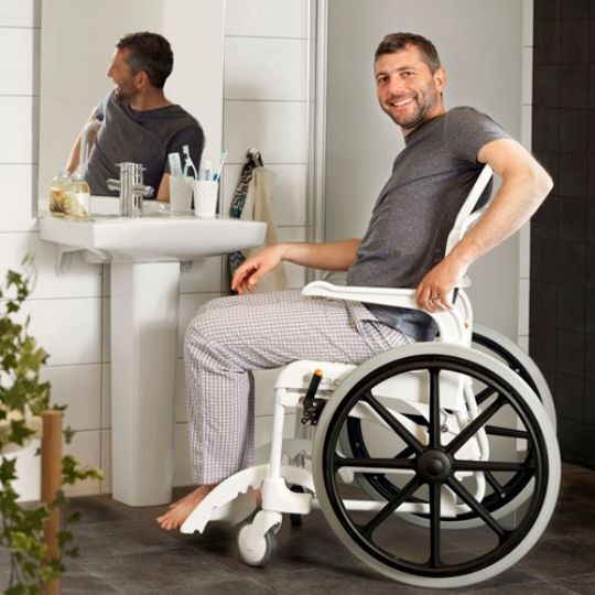 Clean self-propelled commode shower chair in use