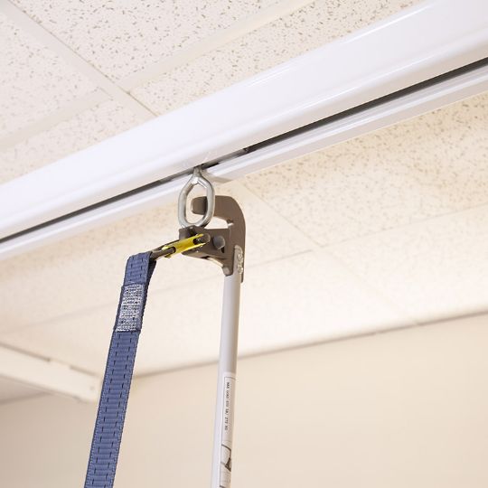 Closer view of a reacher arm removing the ceiling lift  <i>(A reacher arm is sold separately)</i>