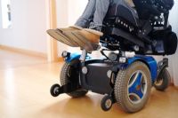 How does a tilt in space wheelchair differ from a reclining back wheelchair?